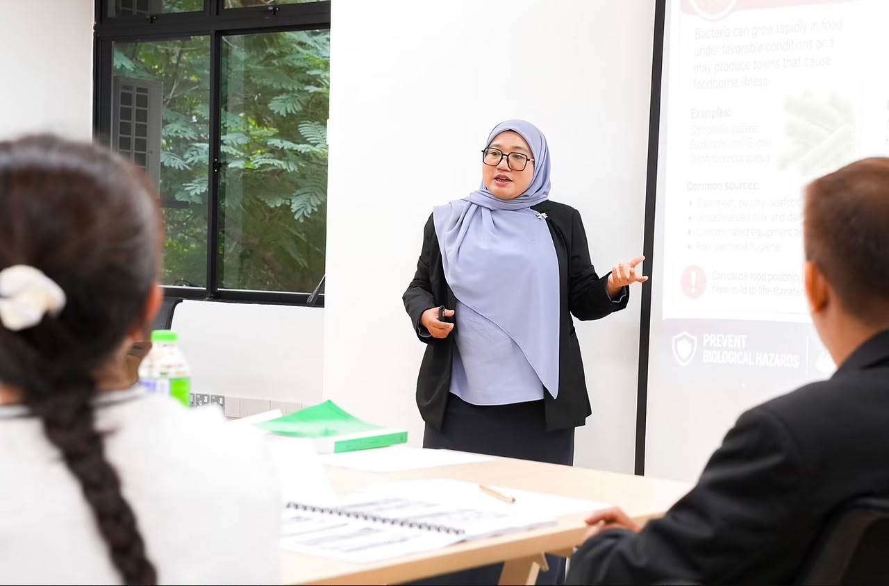 Ts. Natrah presenting food safety training to participants